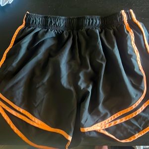 Nike athletic shorts black and light orange.
